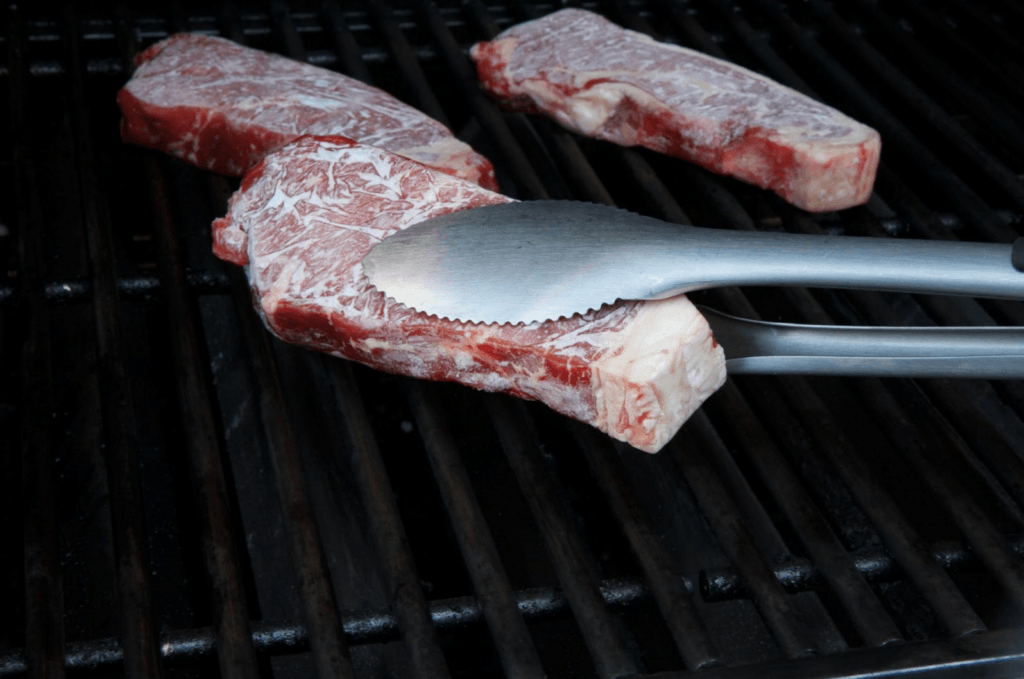 placing your steak on the grill