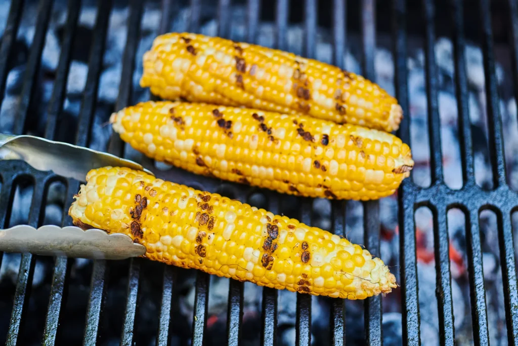 Turning the Corn Place the corn on the grill and let it cook for about 10-15 minutes, turning every few minutes to ensure even cooking.