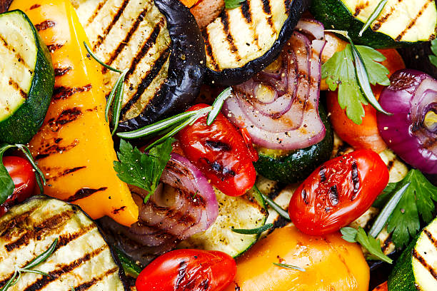What is BBQ Vegetable Salad? Grilled vegetables. On cutting dark board background.