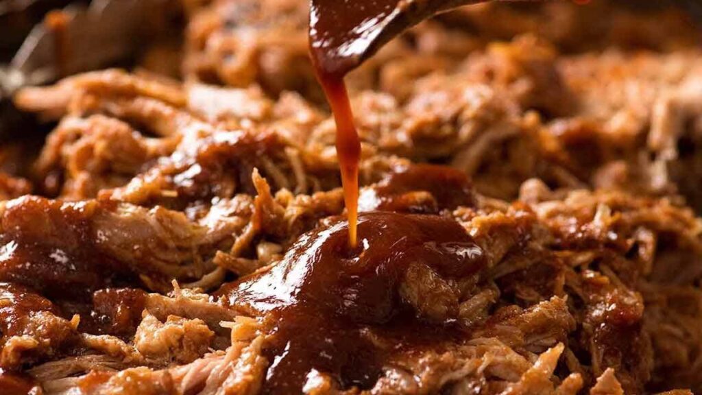 Drizzle your homemade BBQ sauce over the shredded pork. 