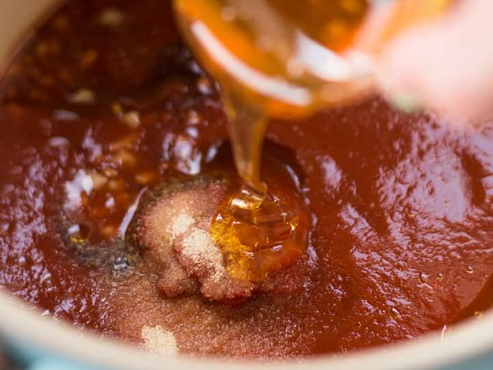 Cooking bbq sauce, adding sugar and honey