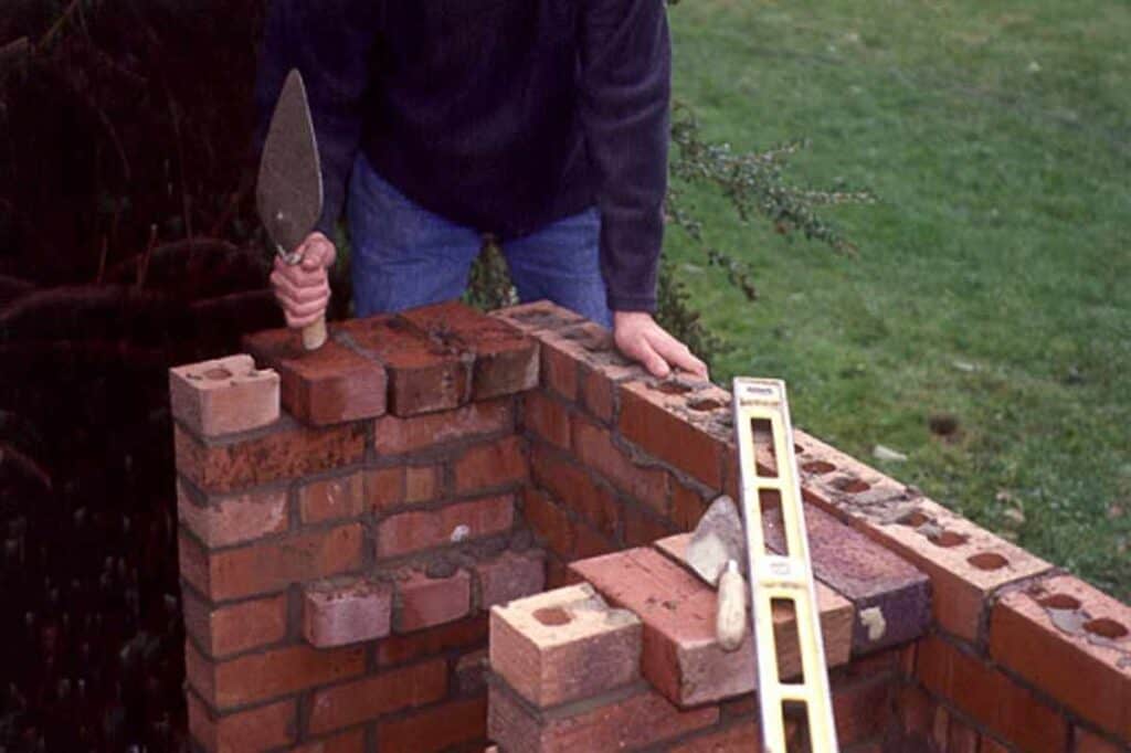 Detailed instructions for constructing a brick barbecue with a chimney.
