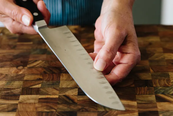 large wooden cutting board iand a sharp knife