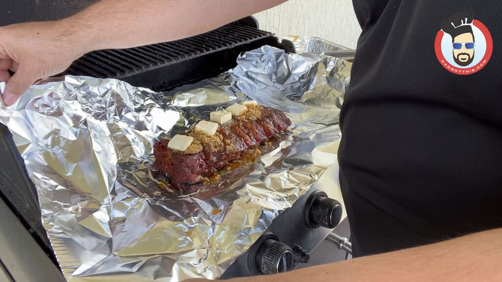 Wrapping the ribs in foil during cooking